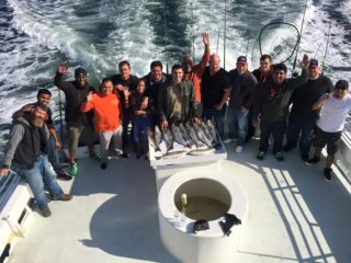 group on back of boat fishing